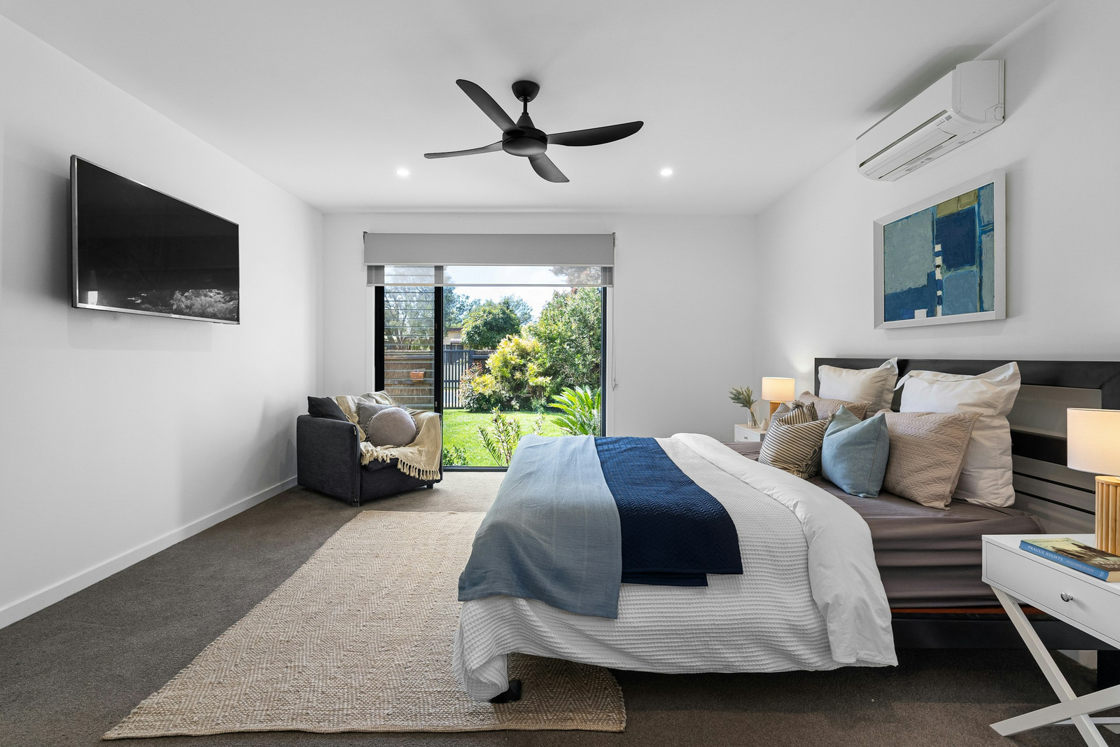 A bedroom with a wall-mounted mini-split